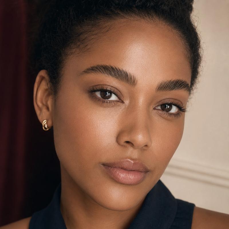 Close-up portrait highlighting a woman’s lashes and brows