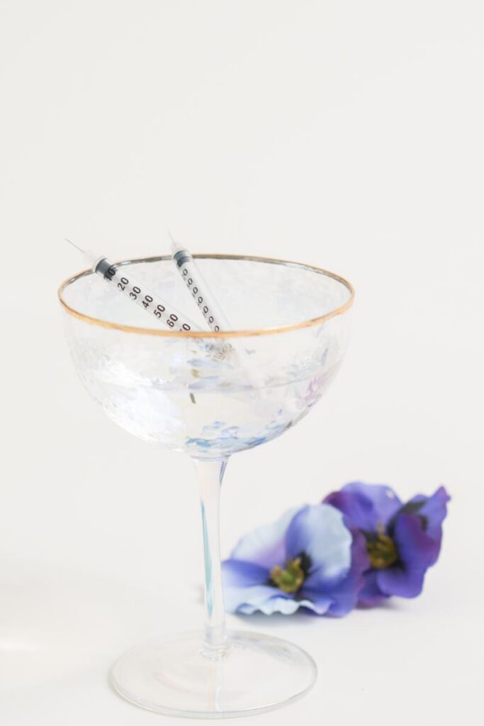 Aesthetic injection syringe displayed with flowers
